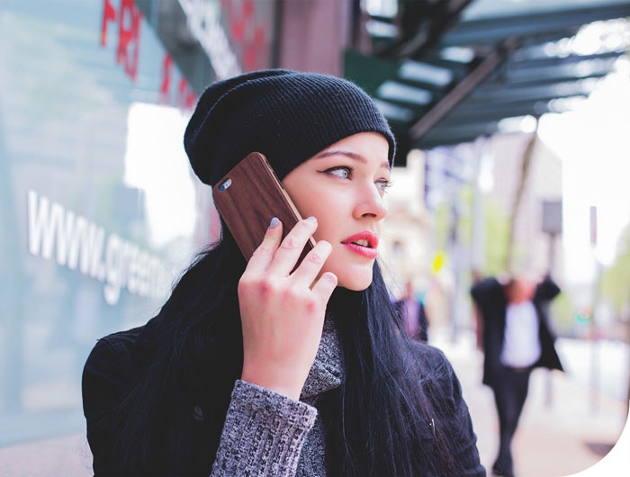 Frau mit Handy am Ohr im Beratungsgespräch